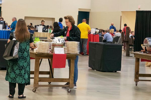 People gather in a cafe in an exhibit hall