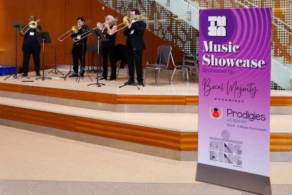 Musicians perform near a sign that says Music Showcase